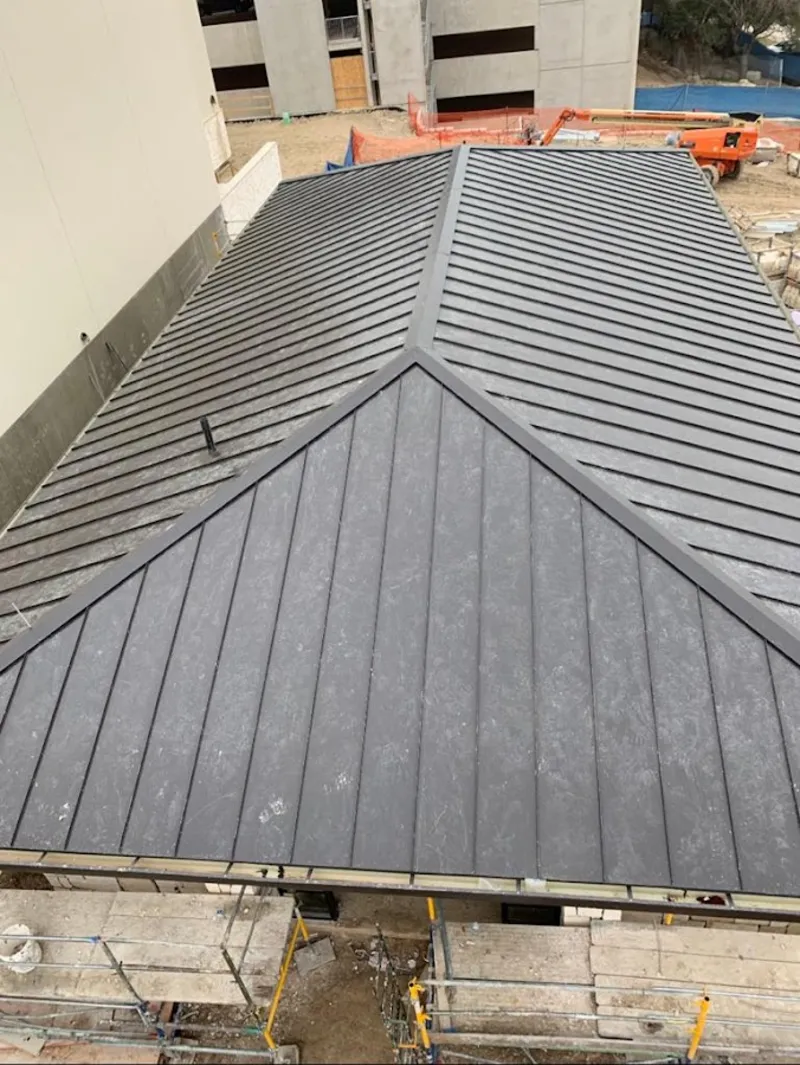 Commercial metal roof construction with crane equipment in Irvine