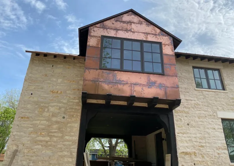 Copper metal panel facade on a stone building for Skylight Installation in Irvine